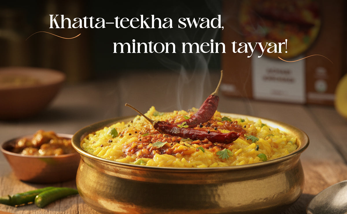 Steaming dish of yellow rice with a red chili pepper on top, garnished with green herbs, in a brass bowl. Text overlay in a foreign language.