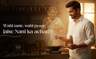 Man cooking with a woman in the background, holding a bottle of Nani ka achar.