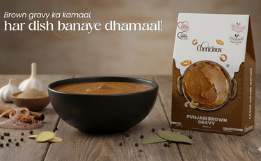 Punjabi brown gravy in a bowl with a box of the product on a wooden surface.