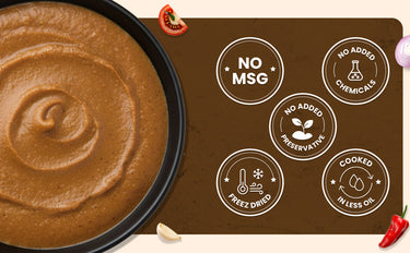 Dip with a brown sauce in a black bowl next to a brown mat with health claims on it.