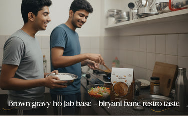Two men cooking in a kitchen with a box of spices on the counter.