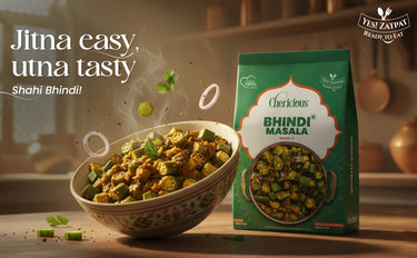 Bowl of Bhindi Masala with a packet of Cherlicious Bhindi Masala on a wooden surface.