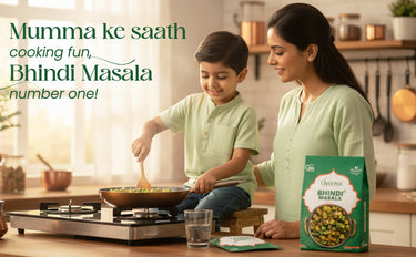Woman and child cooking Bhindi Masala in a kitchen with a box of the product.