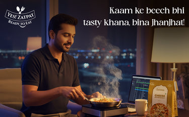 Man cooking food in a kitchen with a laptop and pizza box, featuring Yes! Zatpap brand.