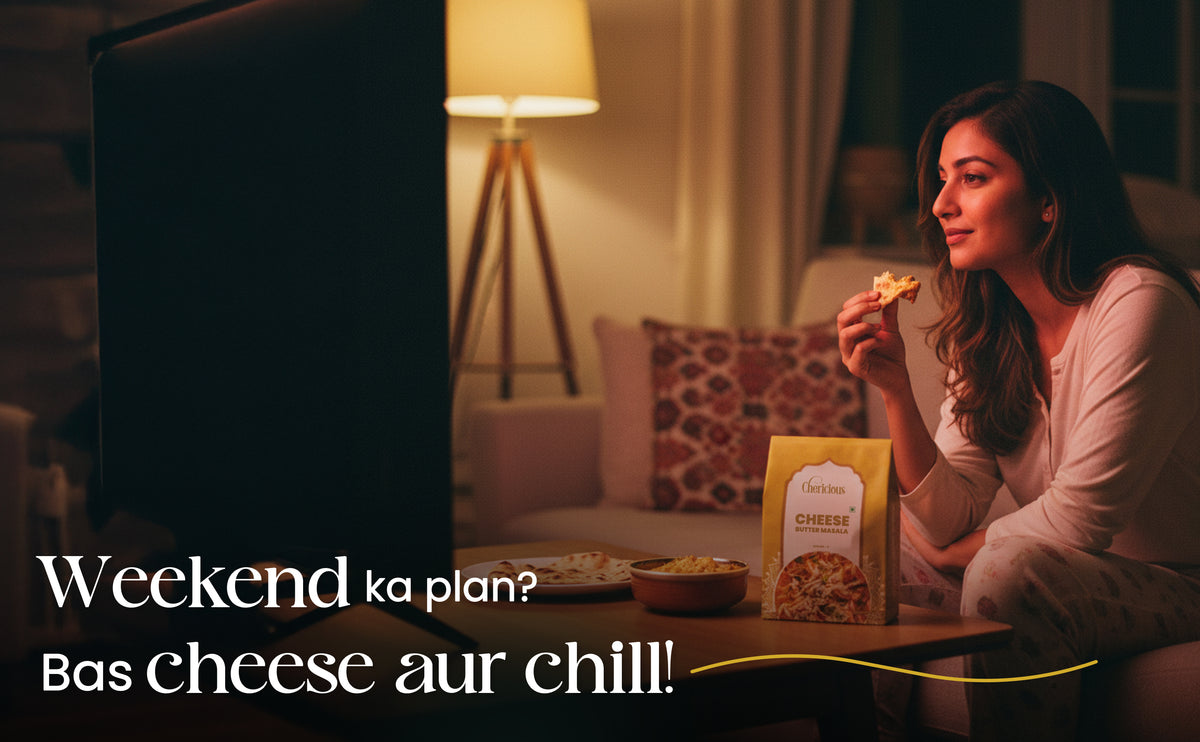 Woman eating pizza with a box of cheese puffs in a cozy living room.