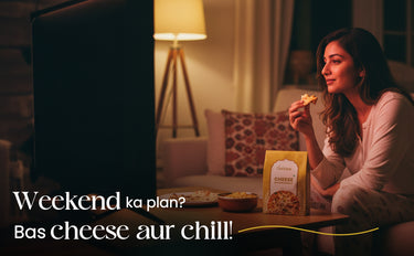 Woman eating pizza with a box of cheese puffs in a cozy living room.