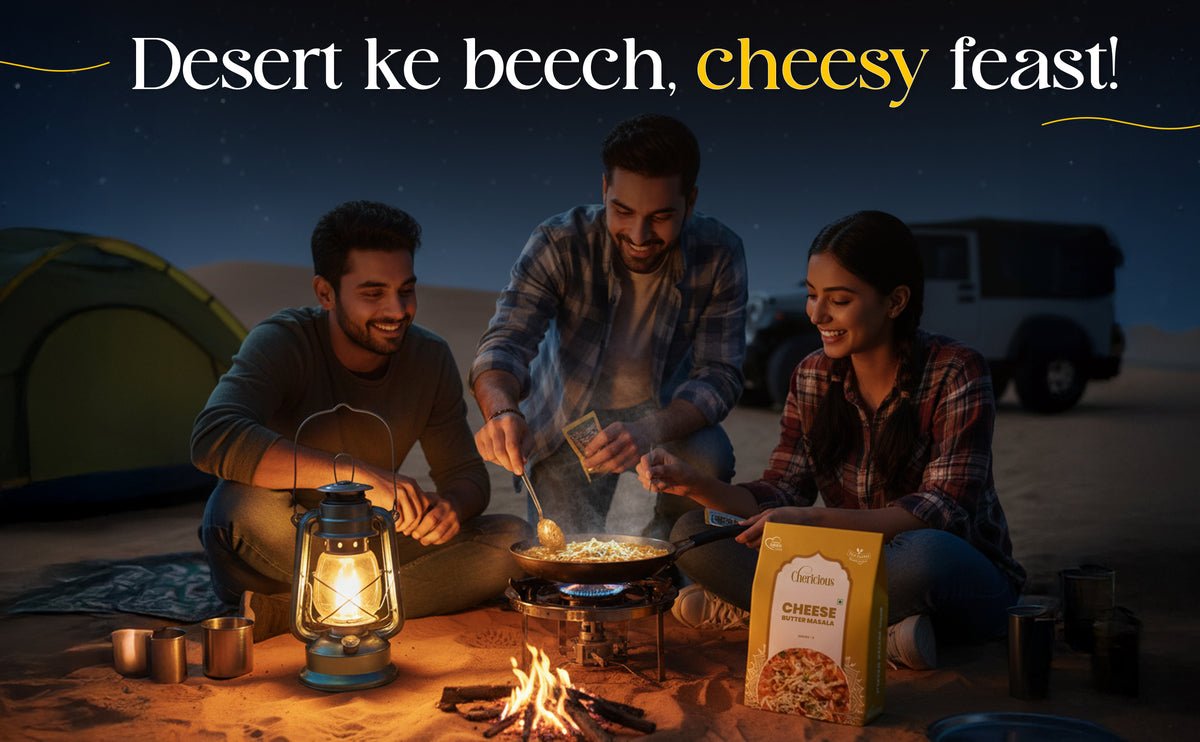 People camping in the desert with a fire and food, enjoying a 'cheesy feast'.