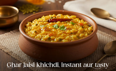Bowl of yellow khichdi with garnishes on a textured surface, accompanied by a spoon and cloth.