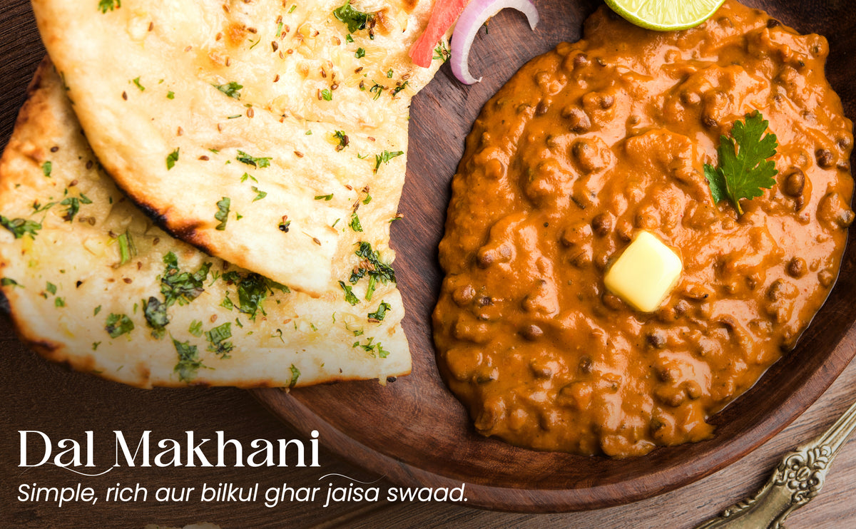 Dal Makhani with naan bread on a wooden plate