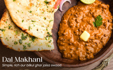Dal Makhani with naan bread on a wooden plate