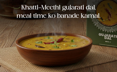 Bowl of Gujarati dal with text on a wooden surface
