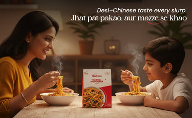 Woman and child eating noodles with a box of 'Noodles' in the foreground.