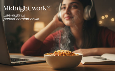 Person wearing headphones, using a laptop with a bowl of food in front of them, text 'Midnight work? Late-night ka perfect comfort bowl!'.