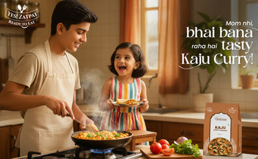 Man and child cooking Kaju Curry in a kitchen with a Kaju brand package.