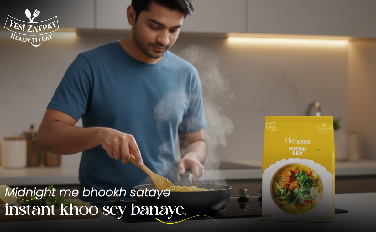 Man cooking food in a kitchen with a 'Yes! Zaifat' product box displayed.