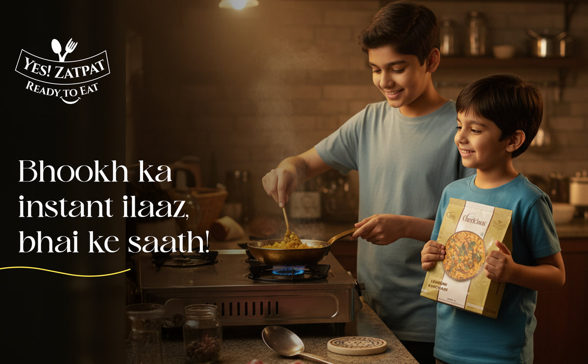 Man and child cooking together in a kitchen with a pizza box.