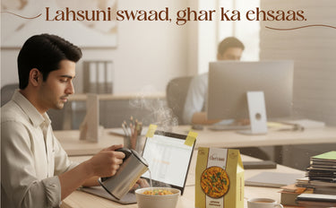 Person using a tablet with a box of cereal on a desk, with another person in the background.