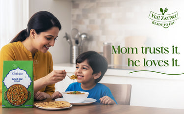 Woman feeding a child at a table with a Yes! Zapatay ready-to-eat product box.