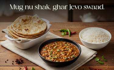 Dishes of food including rice, flatbreads, and a bowl of curry on a wooden table with text overlay.