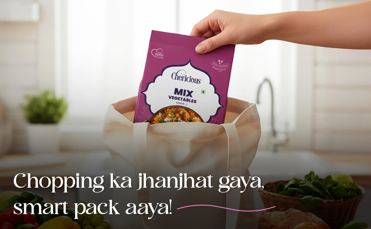 Hand holding a purple package labeled 'Cherilicious Mix Vegetables' over a brown paper bag with kitchen background.