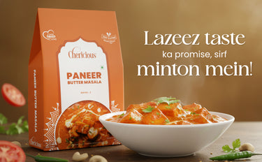 Cherlicious Paneer Butter Masala packaging with a bowl of food on a wooden table.