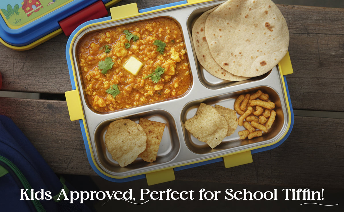 Children's lunchbox with compartments filled with food on a wooden surface