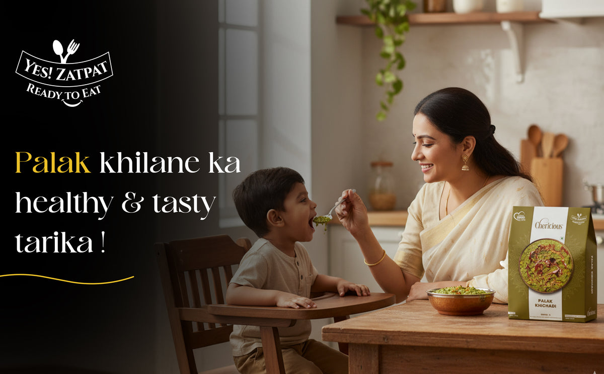 Woman feeding a child at a table with a box of food packaging in the background.