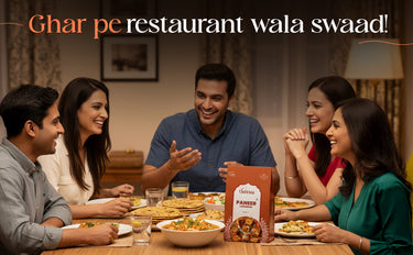 People enjoying a meal together with a package of Paneer in the center.