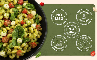 Pasta salad with vegetables on a black plate next to a green label with health claims.