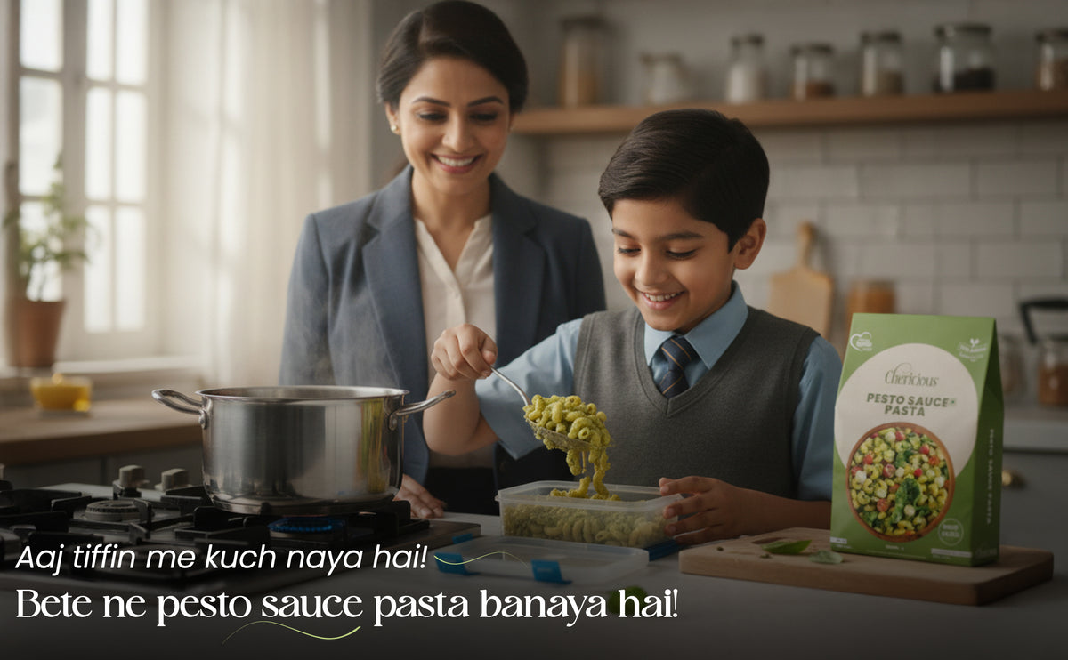 Woman and child cooking together in a kitchen with a box of pesto sauce visible.