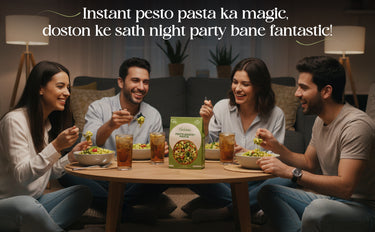 Four friends enjoying a meal together with a box of pasta in the center.