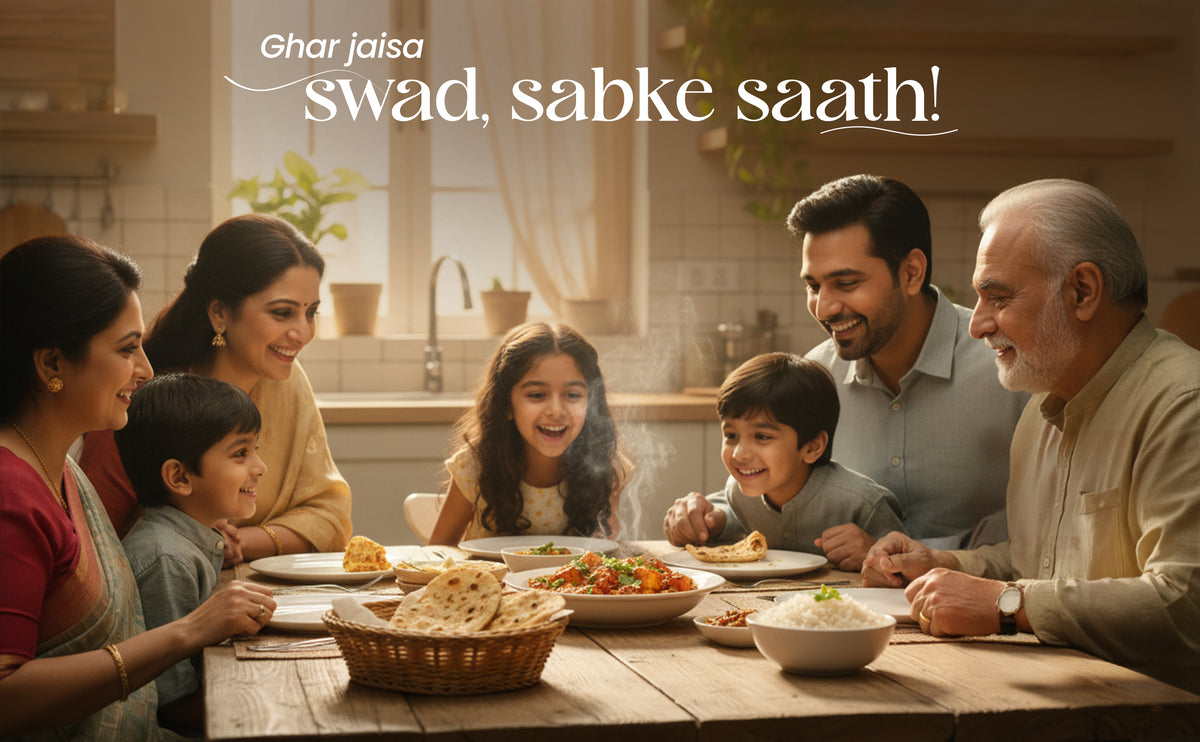 Family gathered around a dining table for a meal with text 'Ghar jaisa swad, sabke saath!' in the background.