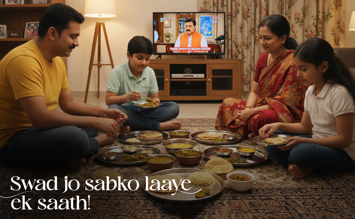 Family sitting together for a meal in a living room with television in the background