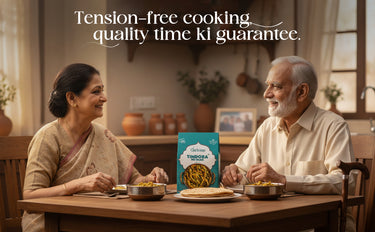 Man and woman sitting at a table with a box of Unione pasta, enjoying a meal together.