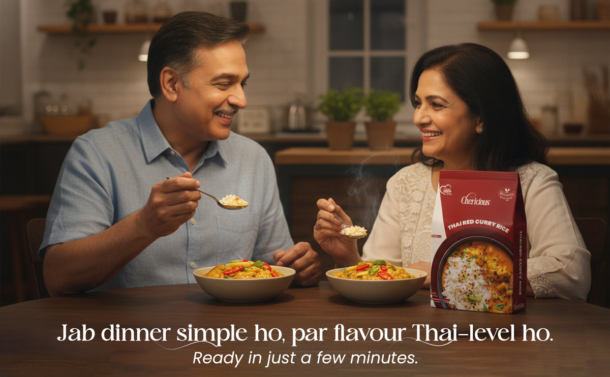 Man and woman eating a meal together with a box of food in a kitchen setting.