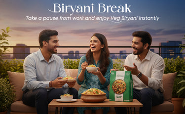 Three people enjoying a bowl of biryani on a rooftop with 'Biryani Break' packaging.