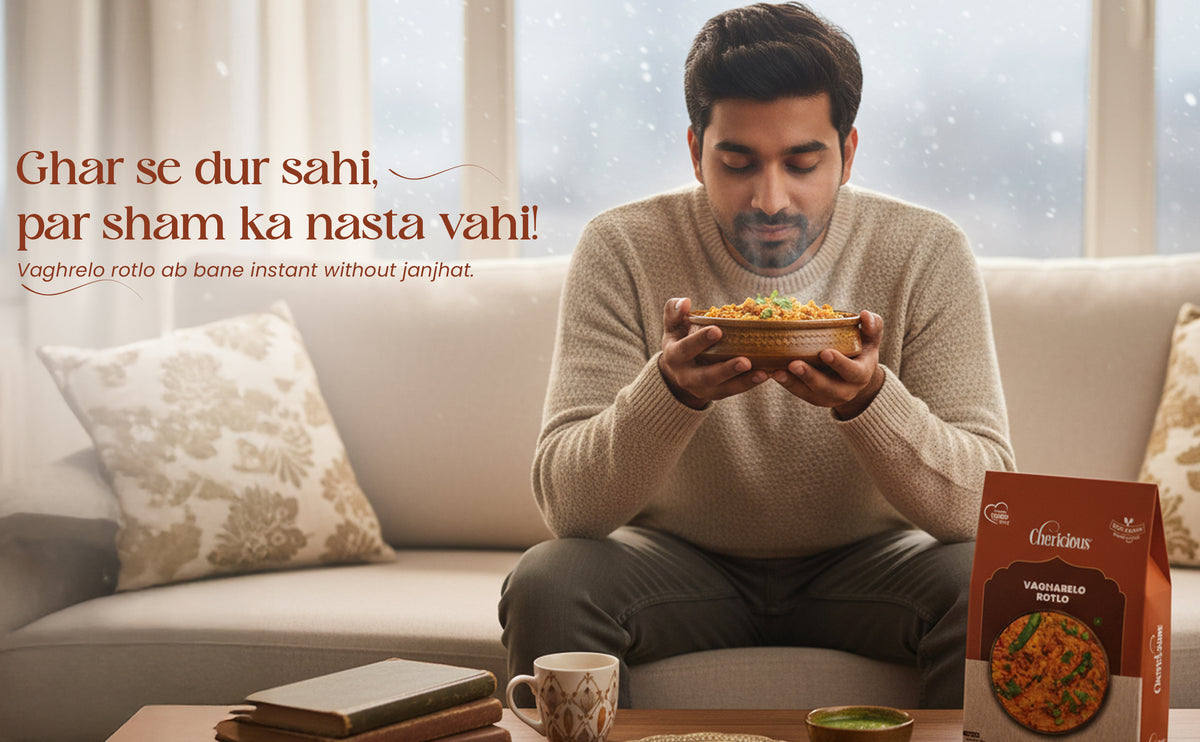 Man sitting on a couch holding a bowl of food with a box of instant noodles next to him.